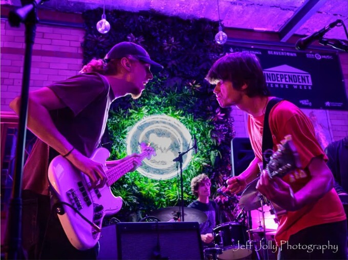 Two guitarists facing each other during a live set at Peggy McCools