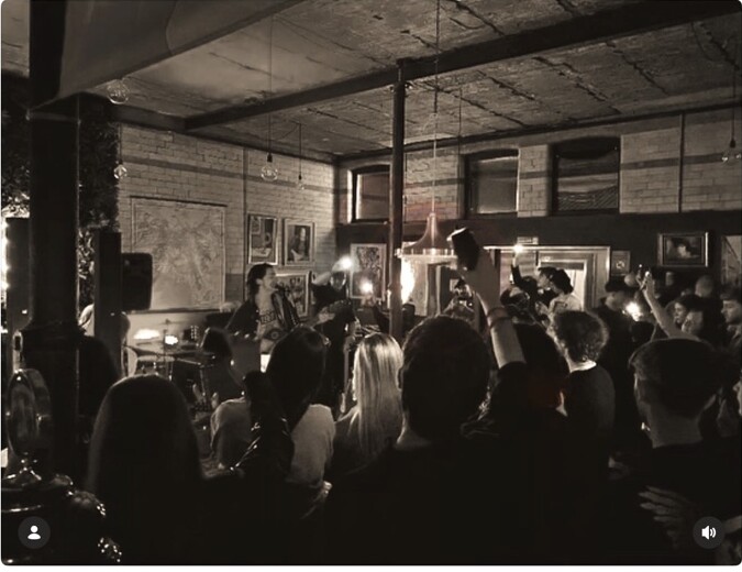 A packed audience watching a live band at Peggy McCools