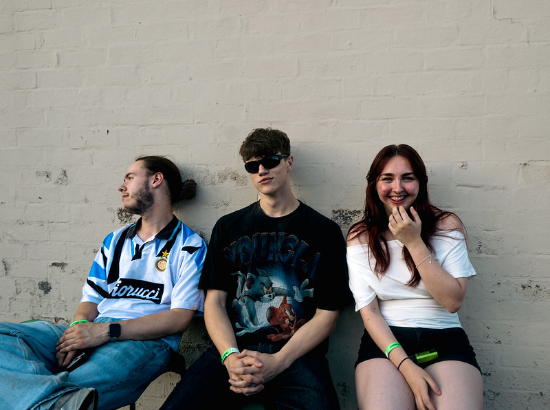 Three giggoers sitting outside Peggy McCools