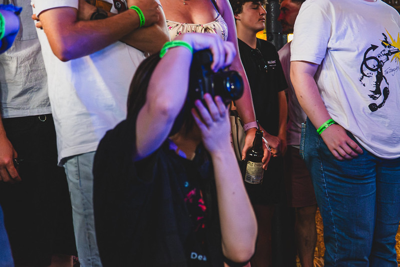 A photographer capturing a gig from inside the crowd